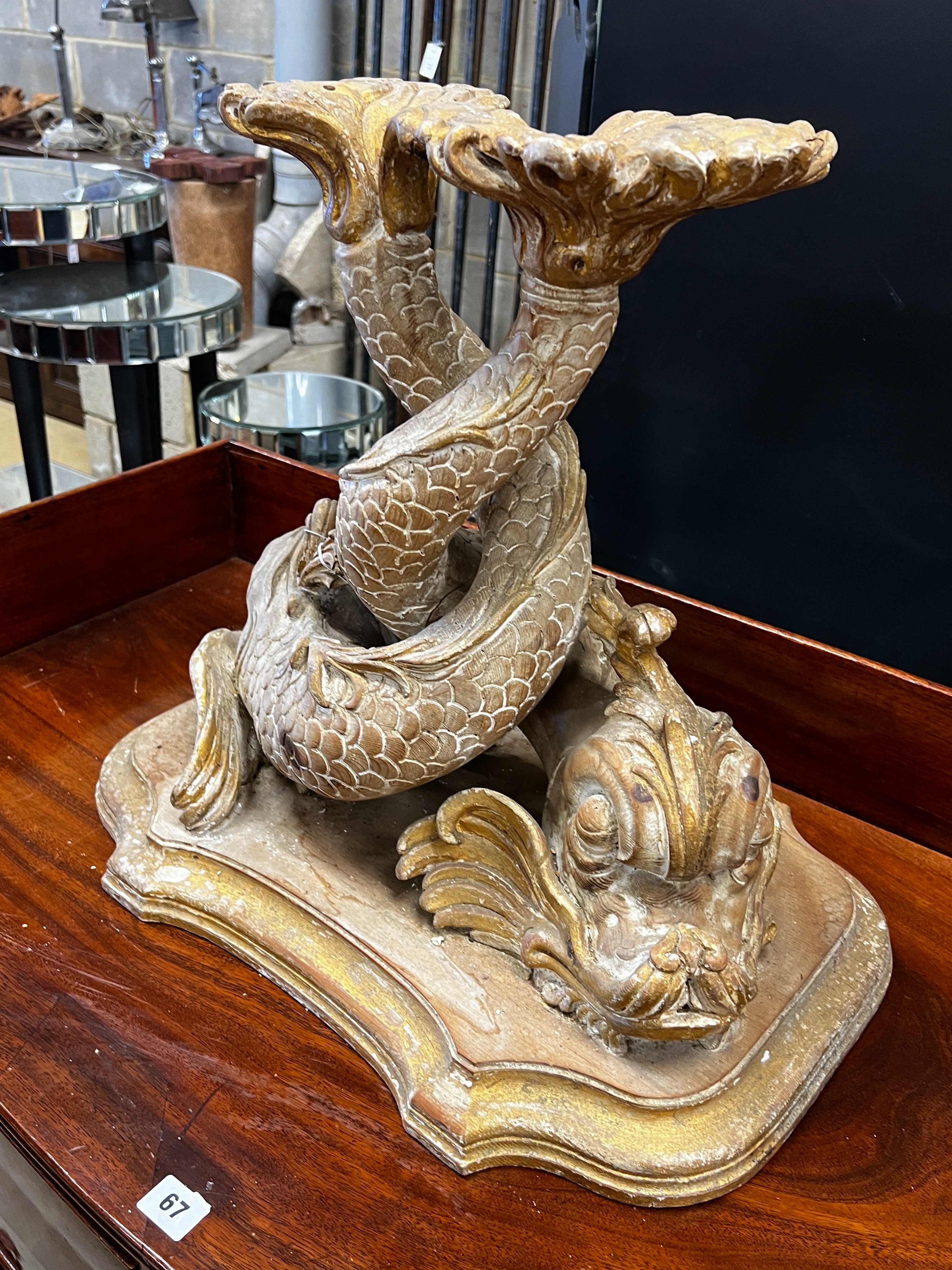 A 19th century carved parcel gilt pine entwined dolphin support, width 54cm, height 50cm